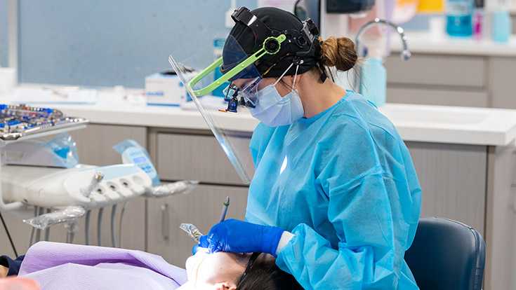 Dental hygiene student treating a patient in the Middlesex College clinic